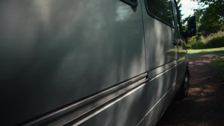 A person opens the door to the van
