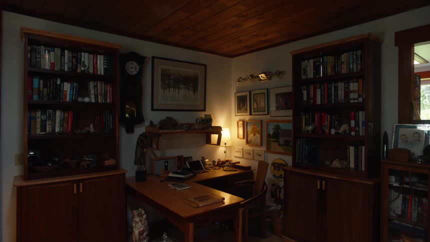 Room with wooden shelves full of objects and books