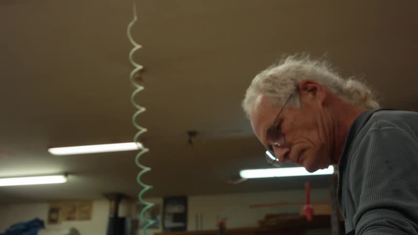 Elderly man in an indoor space working