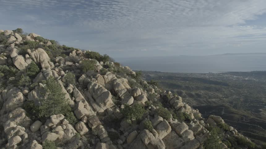 The mountain top is covered with trees and rocks