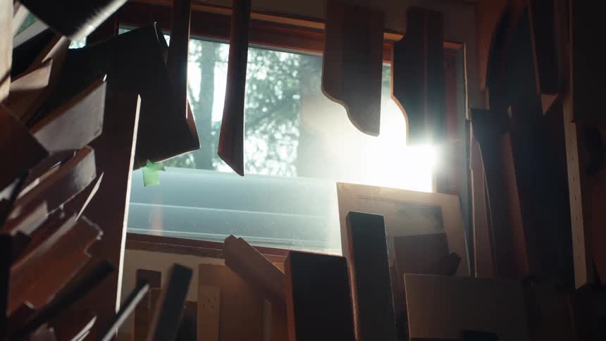 Sunlight filtering through a window with pieces of carpenters wood