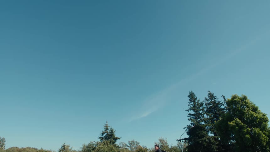 Man riding a bicycle outdoors during a blue sky day