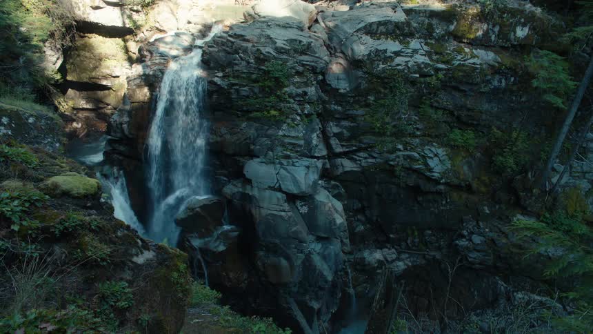 Waterfall flowing over rocks into a ravine in the canyon