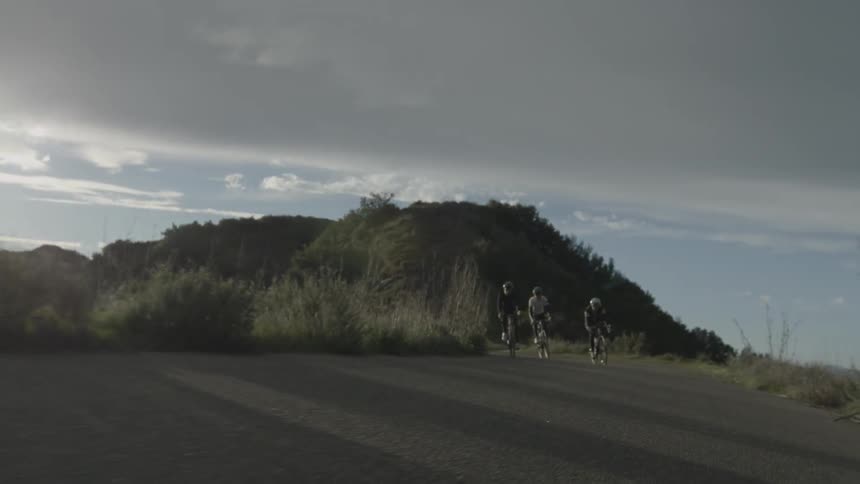 People on bicycles riding at dusk