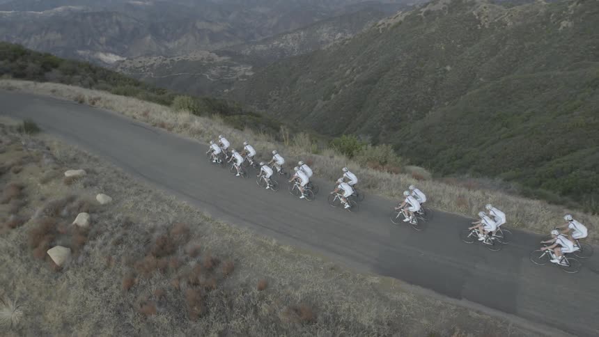 A cycling team rides on a mountain