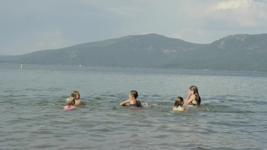 A few kids playing and splashing around in some water