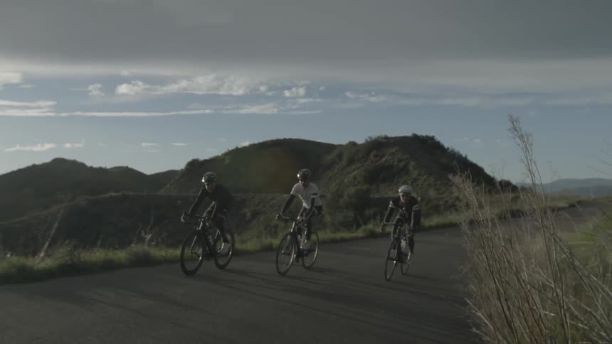 Bicyclists ride on a rural road