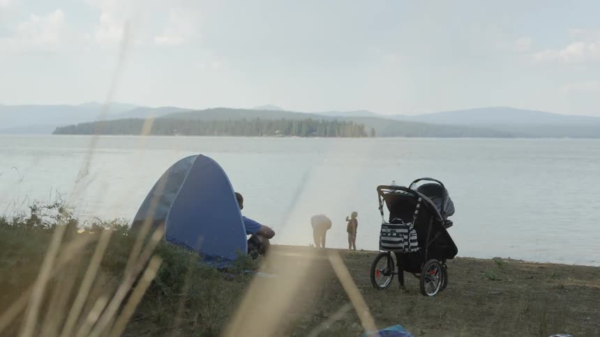 Family on a walk near the shore of a lake