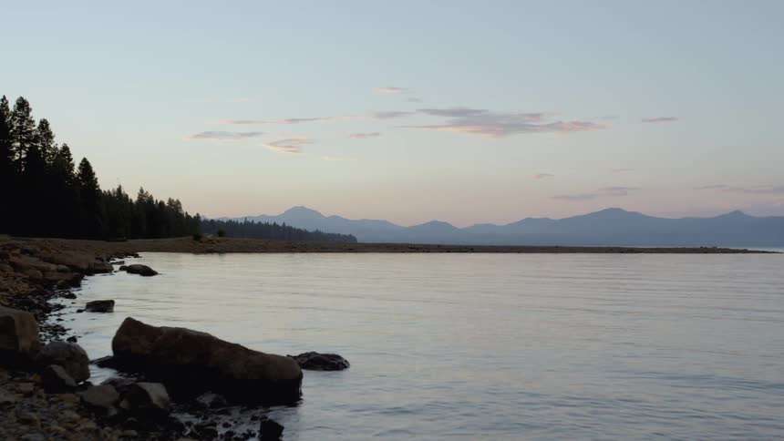 Water flows into the shoreline of a lake