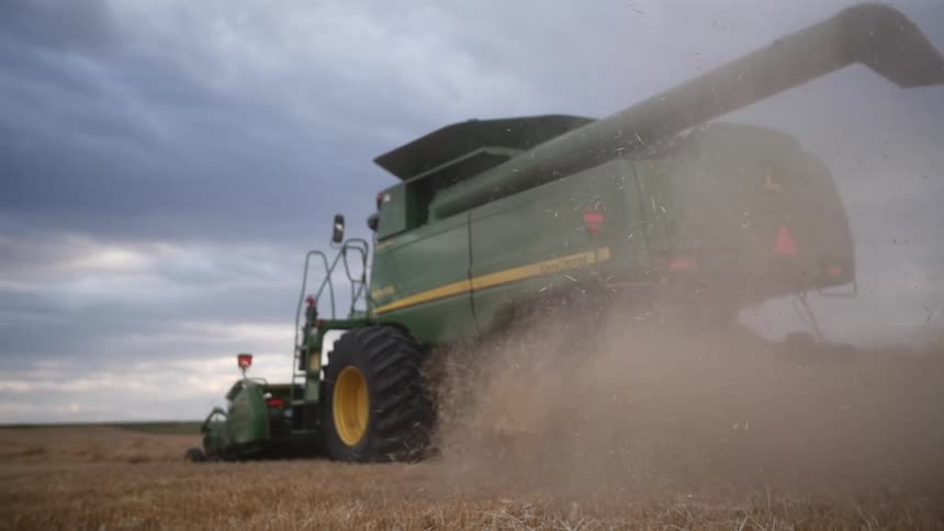 Large green agricultural machine operating in a field