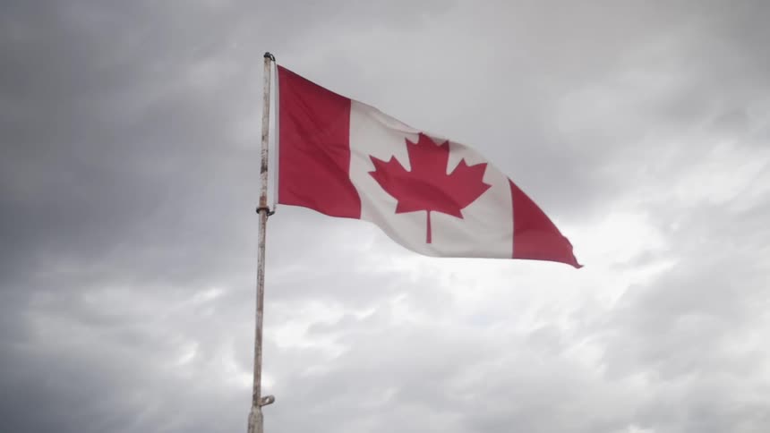 Canadian flag against a cloudy sky