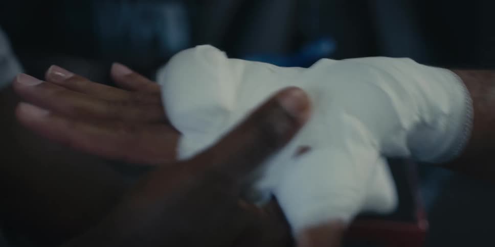 Protective bandage being placed on a mans hand