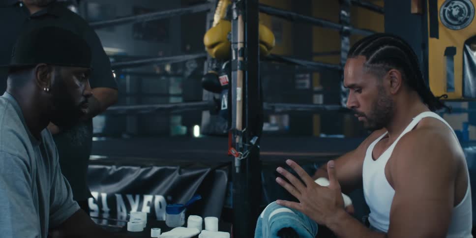 Boxer checking if the bandages on his hands are correct