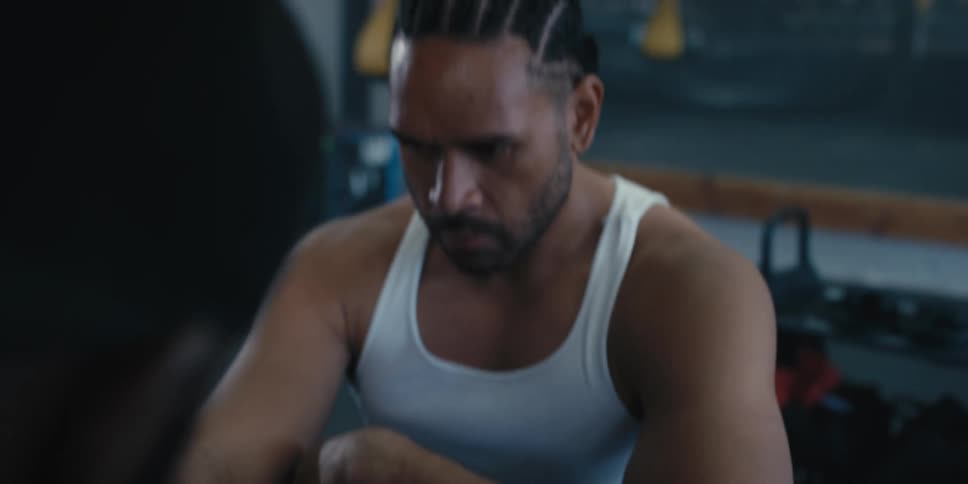 A man is taping up a boxers hand