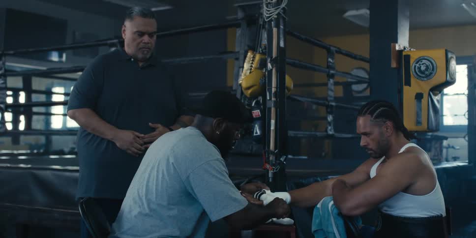 A clip of people beside a boxing ring