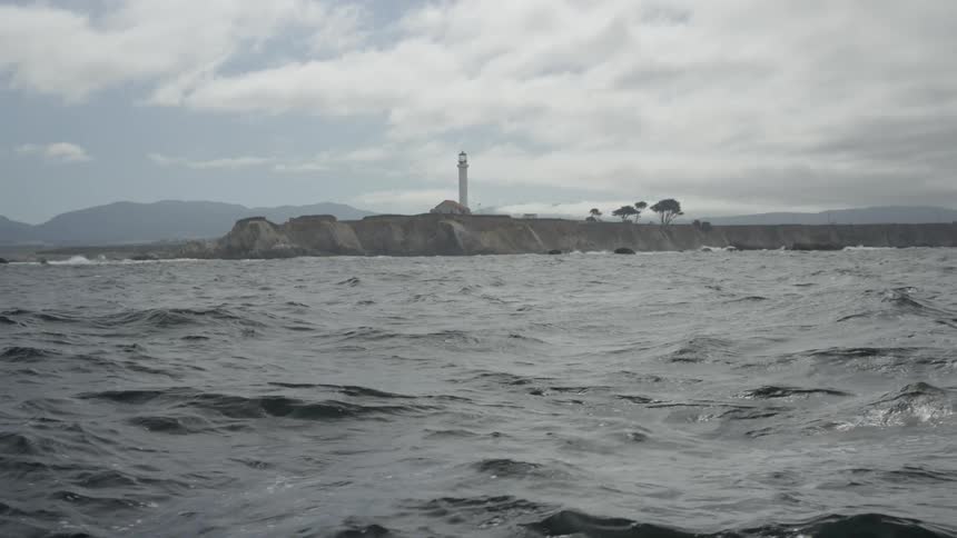 View of a peninsula and choppy waters on a cloudy day
