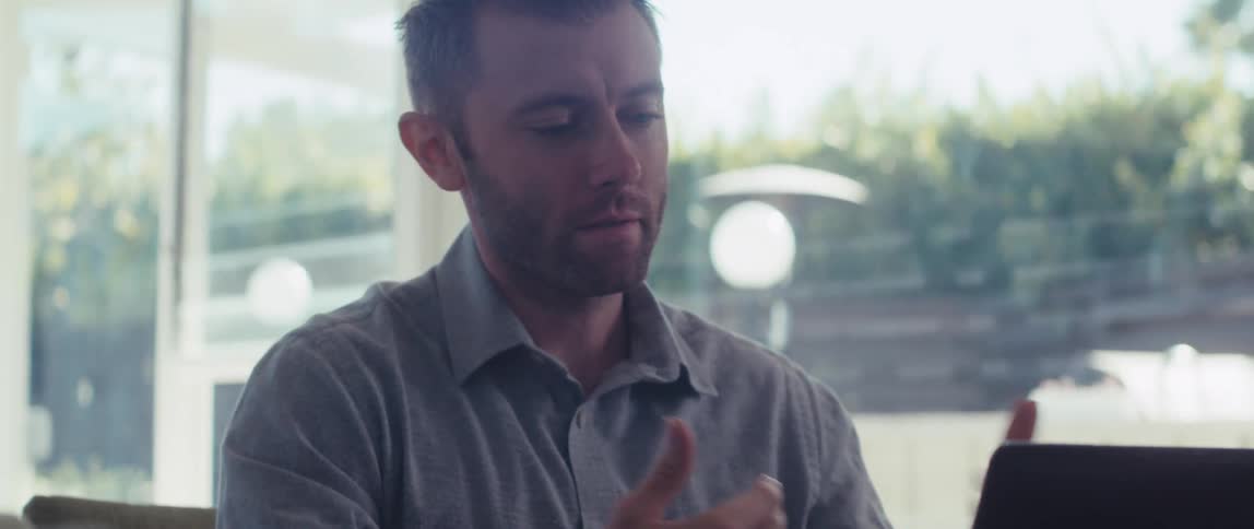 Man sitting interacting in front of laptop