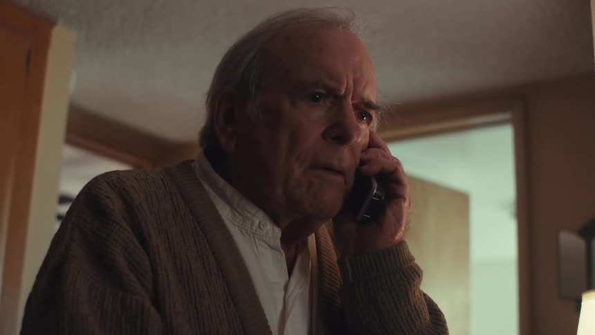 Concerned man answers the phone in his house