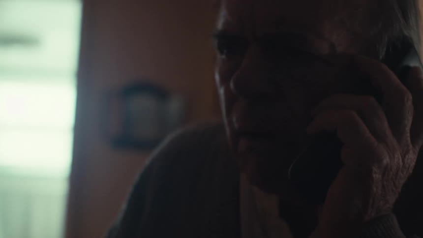 The face of an old man who has the phone to his ear and he looks worried