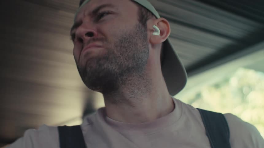 Close up of a man dancing to music in his earbuds