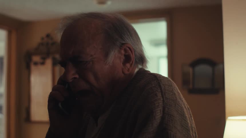 Elderly man a little scared talking on his cell phone