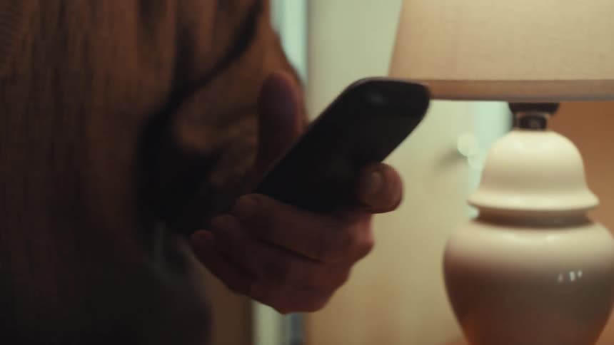 A man picks up the phone and talks with someone