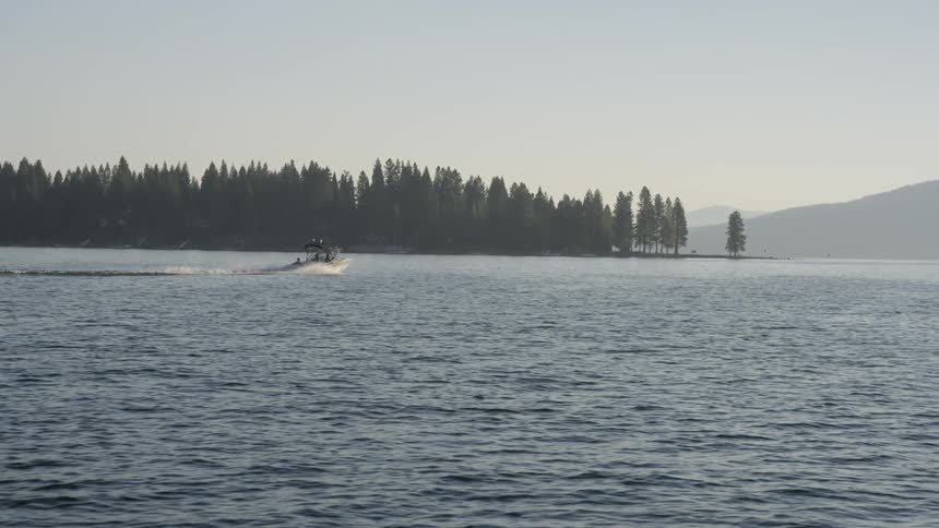 A boat is racing along the water ahead