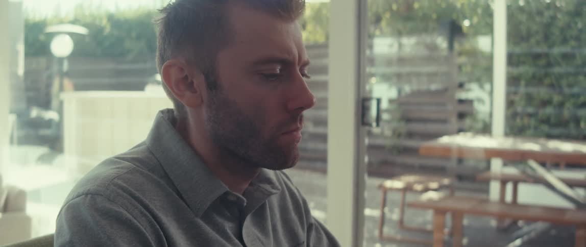 Blond man sitting on chair and nodding