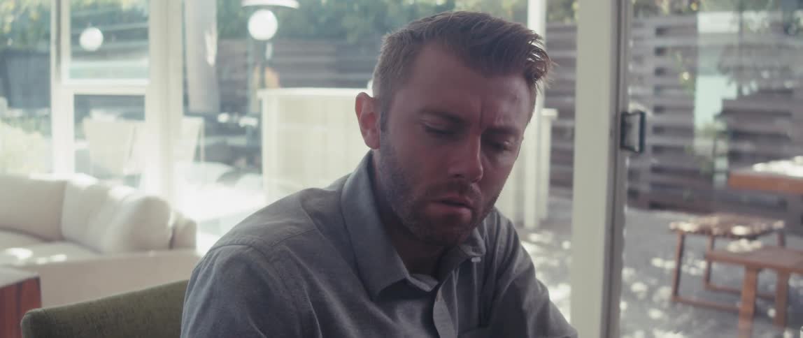 Thoughtful man sitting in front of laptop during daytime