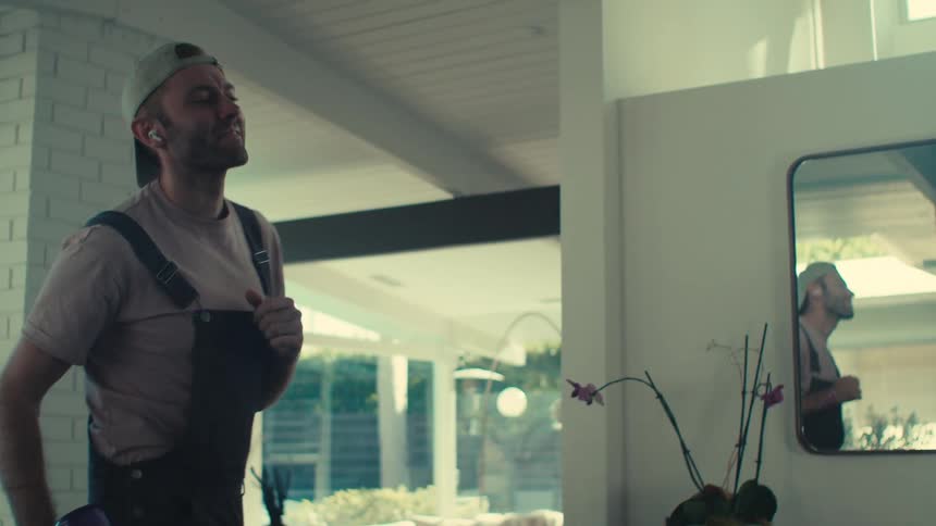 Man cleaning the house while there was music and dancing at the same time