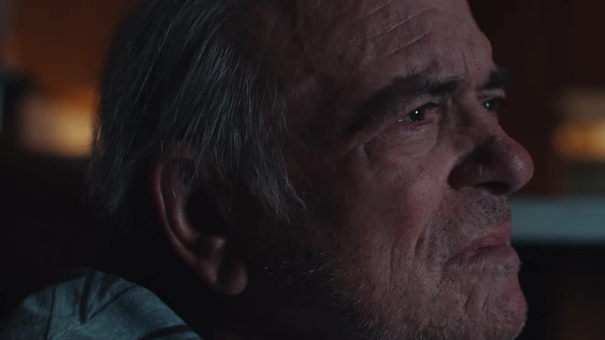 Elderly man sitting focused watching in a room