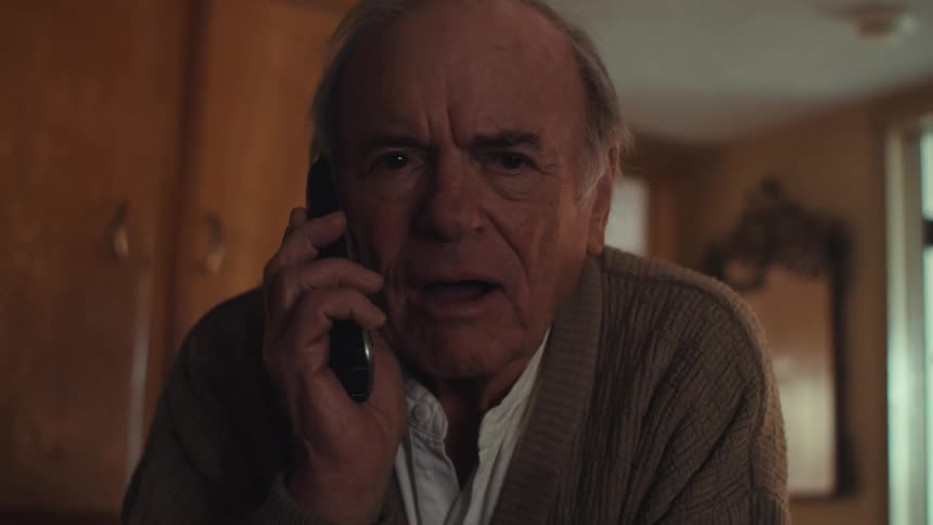 Elderly man talking on the phone on a call