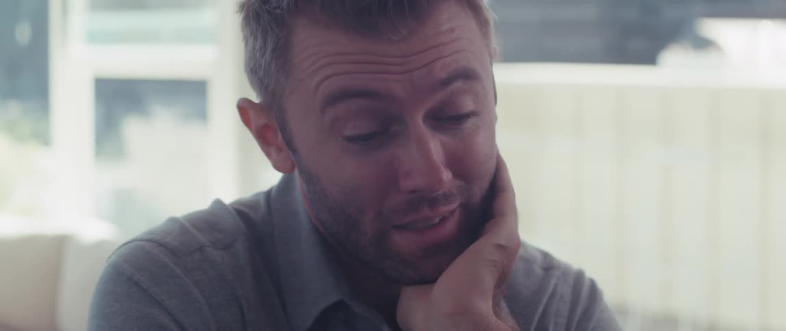 Man placing his hand on his chin while talking