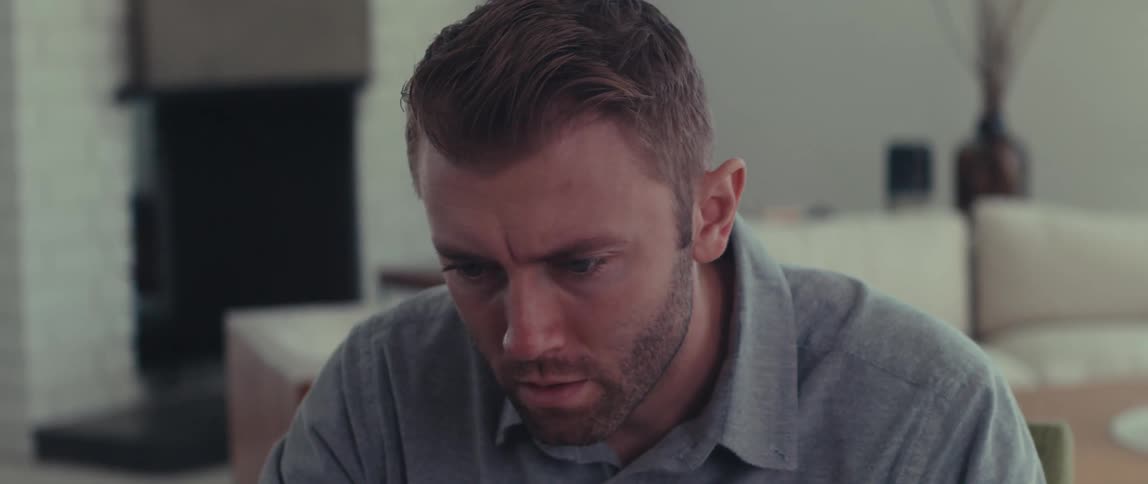 A focused man working in his living room
