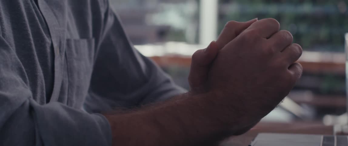 Man sitting and talking in front of a laptop