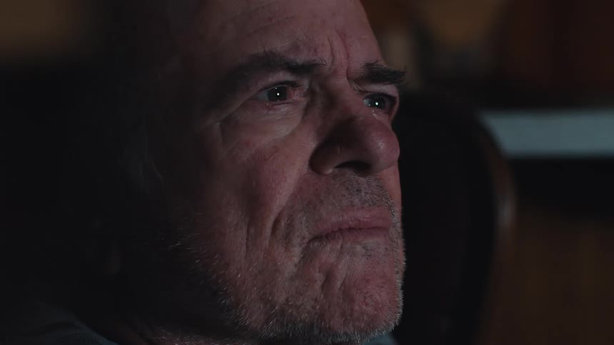 Elderly man sitting watching