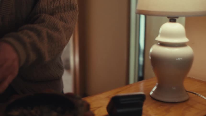 Elderly man answering a phone call