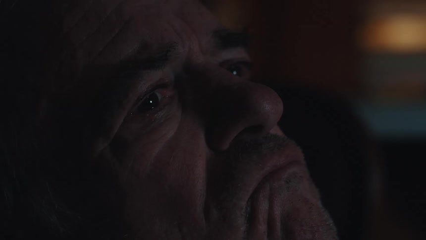 Portrait of an elderly man crying with emotion while watching TV