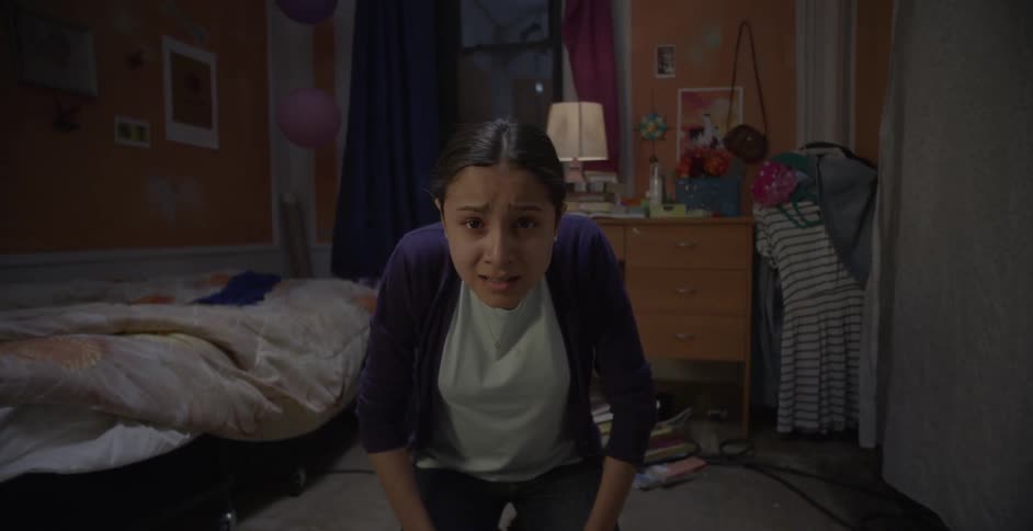 A girl on her knees looks up nervously