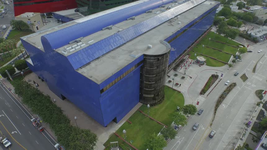Aerial view of a large industrial building next to busy roads