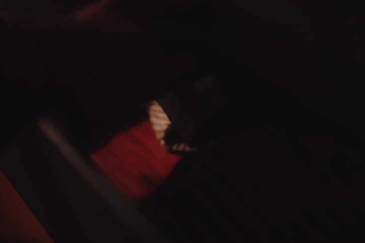 A white male opens a dresser drawer and removes a piece of clothing