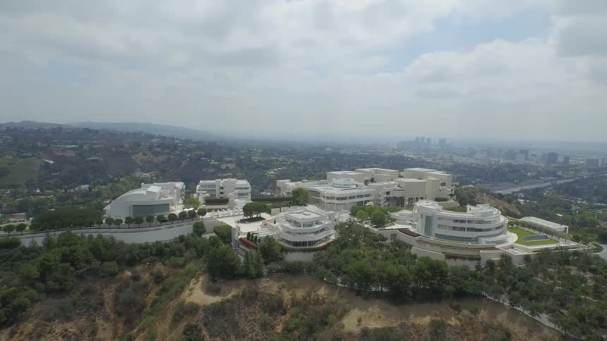 An aerial view of a large building complex on top of a hill
