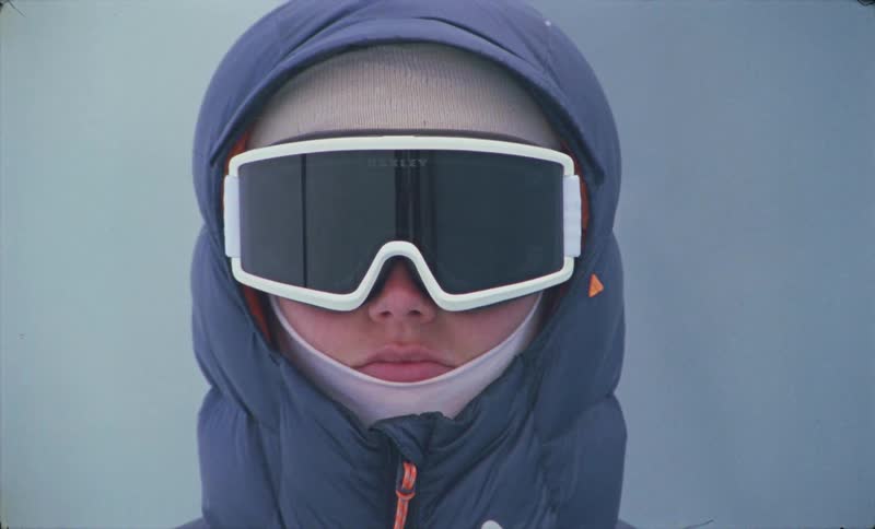 Portrait of a woman in winter jacket and ski goggles