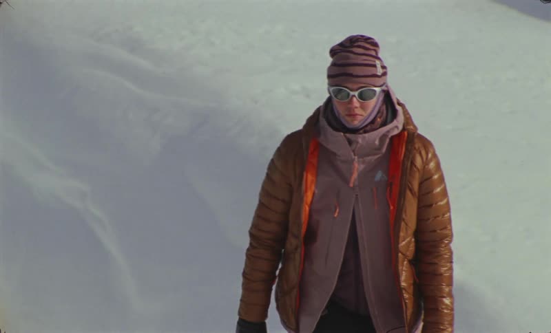 Man and woman walking on a mountain of ice and snow