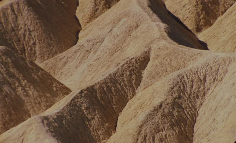 The sun shines on a series of mountainous ridges in nature