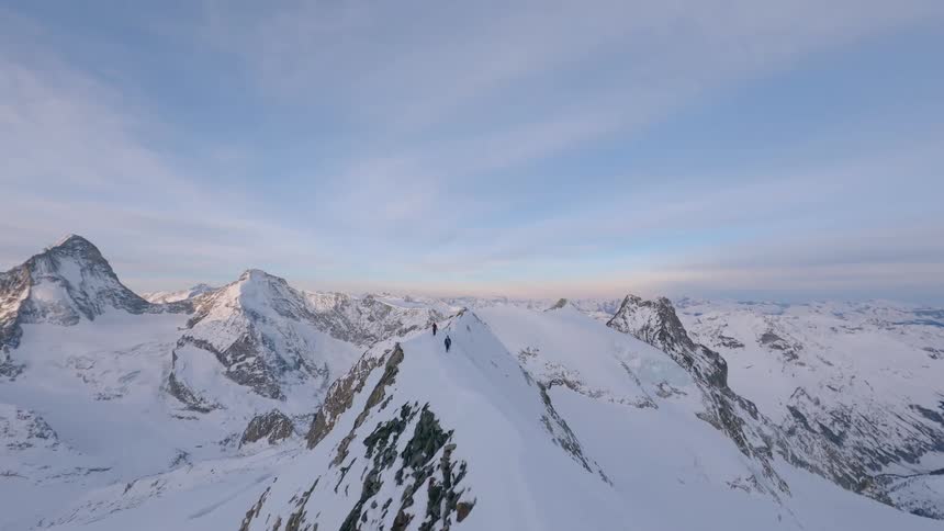 People are hiking on the mountain top with skis in Switzerland