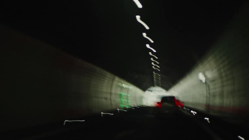 Cars driving fast through a tunnel