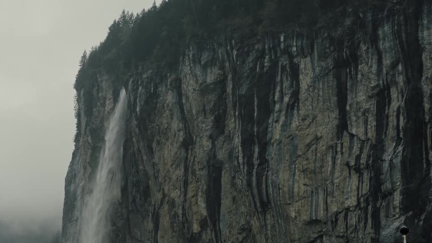 Landscape of a mountain cliff with a waterfall
