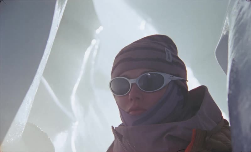 Woman bracing herself against a wall in a tight ice cave