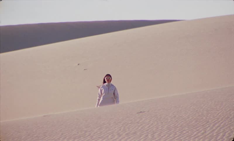 An image of a female walking in the desert